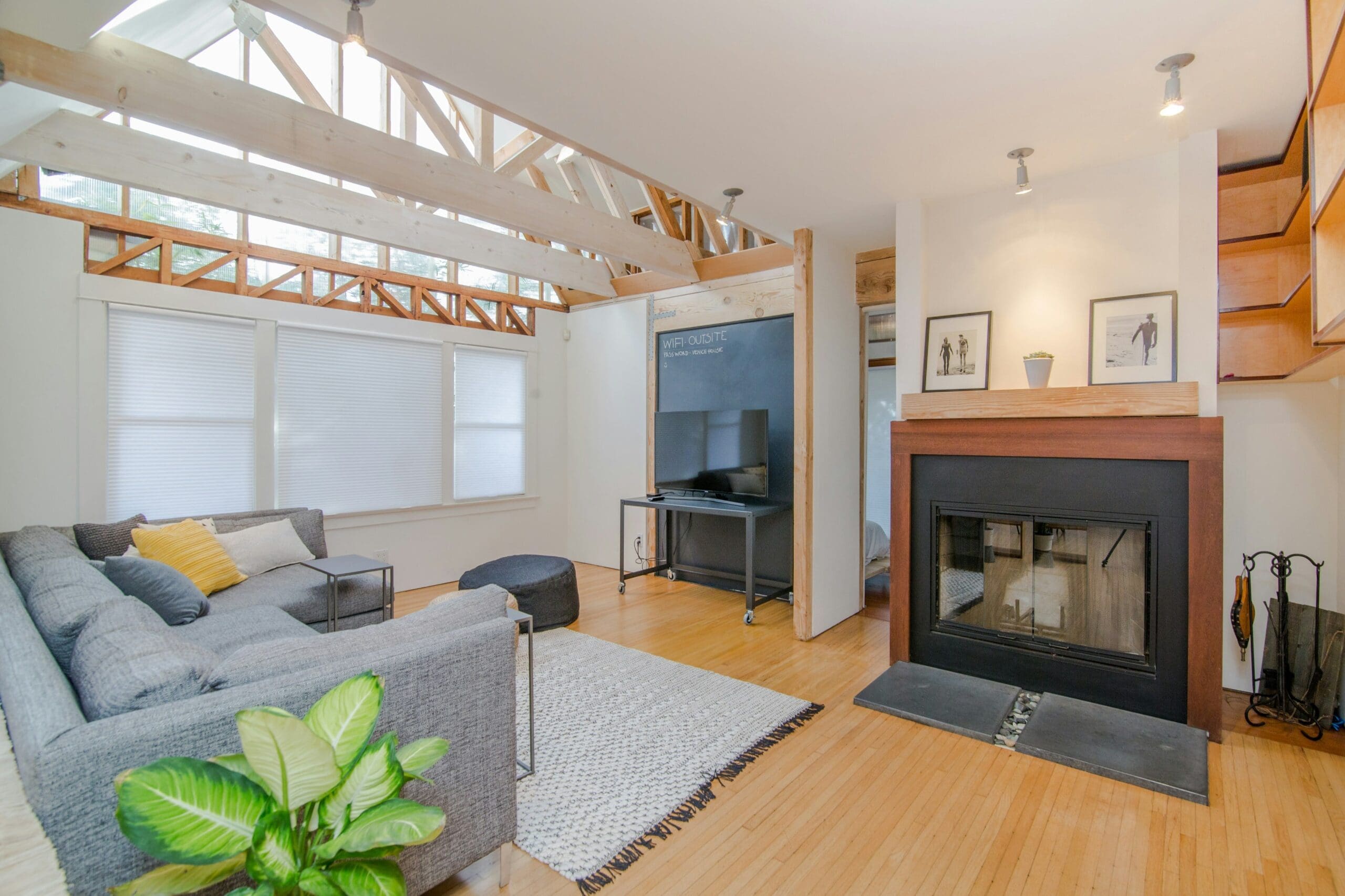 Bright modern living room with skylights, fireplace, sectional sofa and hardwood floors